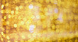 Abstract golden bokeh background texture.