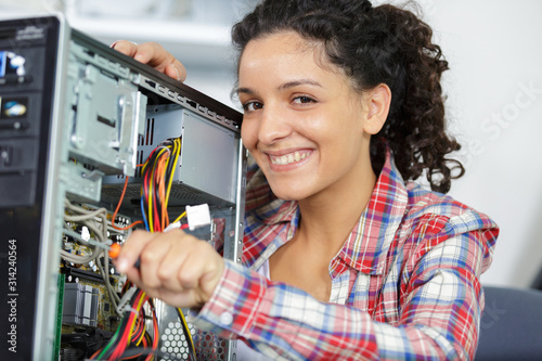 happy female technician fixing computer