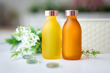 two yellow jars of cosmetics stand naked on the table