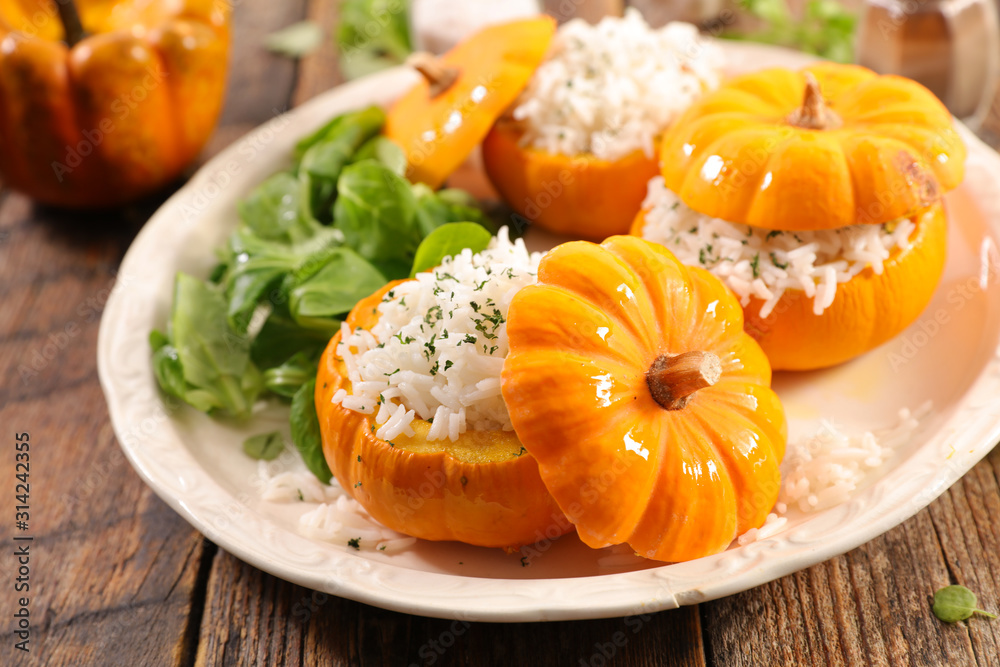 baked pumpkin with rice and salad - obrazy, fototapety, plakaty 