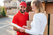 Image of cheerful delivery man giving order to caucasian woman