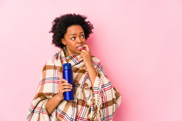 Wall Mural - Middle age african american woman in a camping isolatedrelaxed thinking about something looking at a copy space.