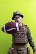 © .shock - solder holding american football ball