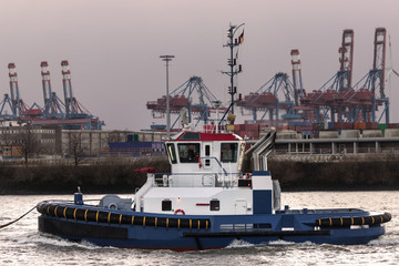 Wall Mural - haulier ship in an container port in the evening