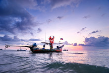 Beautiful Sunset On The Sea With Traditional Thai Longtail Boats.