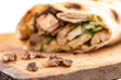 Doner Kebab Gyros Shawarma beef or chiken roll in pitta bread  sandwich on wooden desk