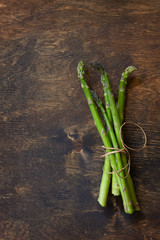 Superfood. Green asparagus on rustic wooden background. Copy space.