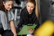 © gpointstudio - Fitness instructor and young woman talking at gym