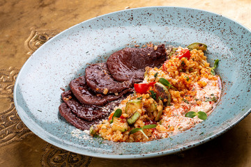 Veal tongues, stewed with bulgur. Classic retro Russian dish