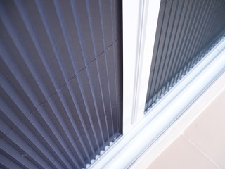 selective focus on white frame door with mosquito net wire screen.