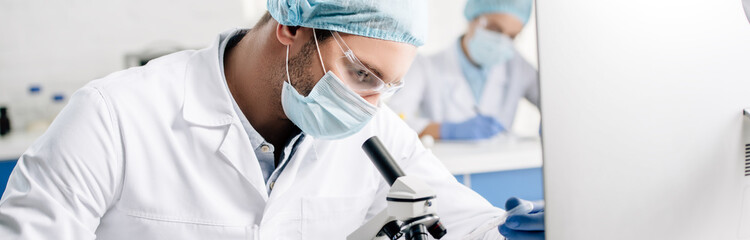 Wall Mural - panoramic shot of genetic consultant doing dna test in lab