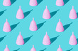 Pink menstrual cup on a green background. Set. Texture
