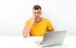 © luismolinero - Young blonde man in a table with a laptop nervous and scared