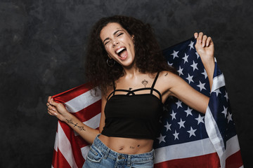 Poster - Image of excited caucasian woman screaming and holding american flag