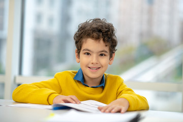 Happy little boy having first lesson in the morning