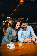 Poster - couple using smartphone in restaurant