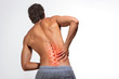 © BigBlueStudio - Human spine illustration,backache, man holding his hand in the back pain area