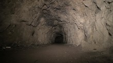 Speleology Artificial Cave Dark Tunnel Excavation Underground. Old Adit For The Extraction Of Metal And Rocks