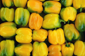 Wall Mural - Natural yellow bell peppers background.