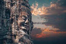 The Bayon - Khmer Temple At Angkor Wat In Cambodia. Popular Tourist Attraction. Smiling Stone Faces On The Towers Of Temple. Dramatic Sky.
