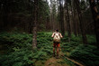 © Seleznov_Molchanova - Closeup portrait of young hiker hiking, looking up at trees.