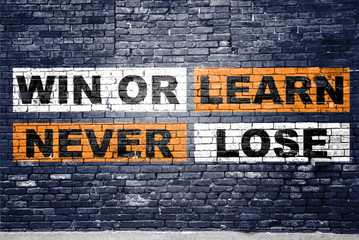 Win or learn never lose saying lettering Graffiti on Brick Wall