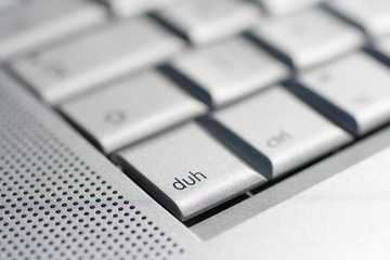 Close up shot of a laptop keyboard with a duh key in focus.