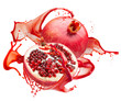 pomegranates in red juice splash isolated on a white background