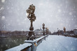 Alexander III bridge covered with snow in Paris
