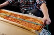 Measure pizza length with a tape measure