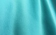 Turquoise satin background. Silk fabric with pleats. Satin, silk or satin create a beautiful drape. Fashion design, background.