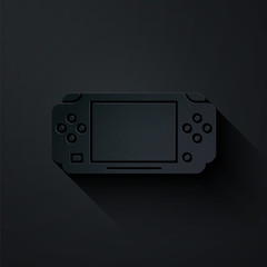 Poster - Paper cut Portable video game console icon isolated on black background. Gamepad sign. Gaming concept. Paper art style. Vector Illustration