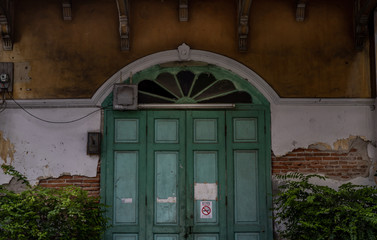 Wall Mural - Old wood vintage door on the old broken wall with visible bricks texture was left to deteriorate over time, Western Architecture style.