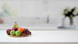 Leinwandbild Motiv Close up view of fruit tray and copy space on marble desk with blurred kitchen room