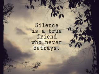 Wall Mural - Motivational and inspirational wording - Silence is a true friend who never betrays. Blurred vintage styled background.