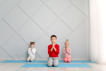 Wall Mural - Little children practicing yoga in gym