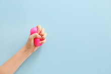Female Hand Squeezing Stress Ball On Color Background