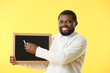 © Pixel-Shot - African-American teacher with chalkboard on color background