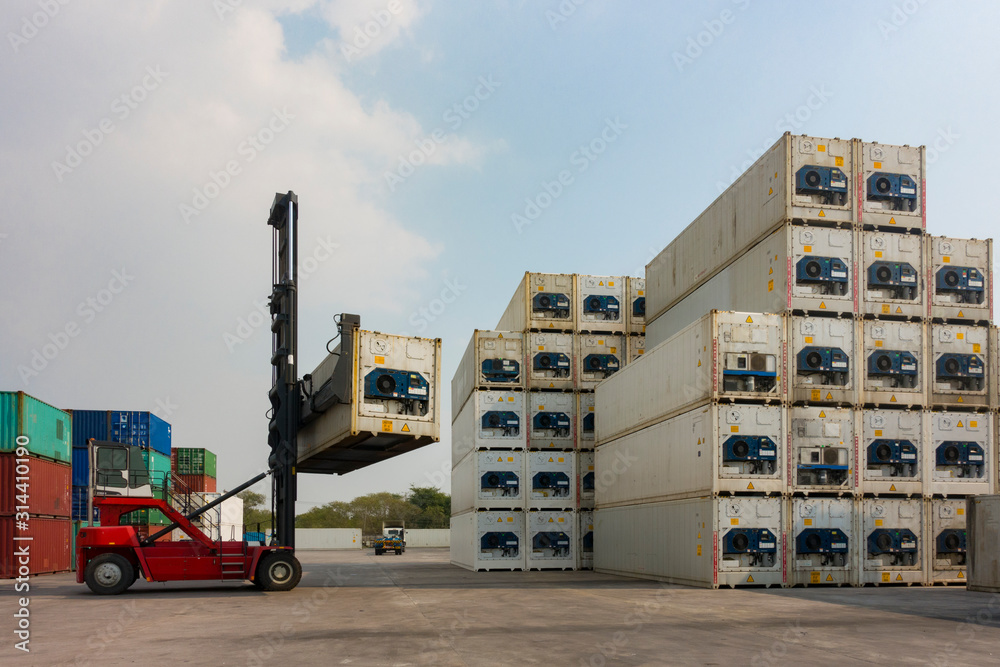 Reefer Container Stacks Forklift reach stacker is lifting the reefer container in the container ...