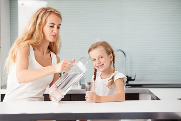 Child with mother drinking water