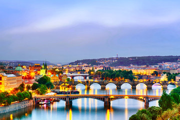 Wall Mural - Prague at twilight sunset. Evening cityscape view of bridges on Vltava