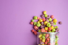 Multicolored Fruit Flavored Popcorn In Glass Cups On Pink Background. Candy Coated Popcorn.