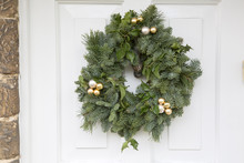 Green Leaf Christmas Wreath On Wooden Front Door