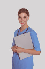 Wall Mural - A female doctor with a folder, standing isolated on white background