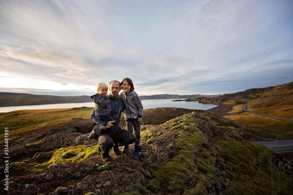 Family posing in Geothermal area in Reykjanesfolkvangur, enjoying the view of a splendid nature in Iceland - obrazy, fototapety, plakaty 