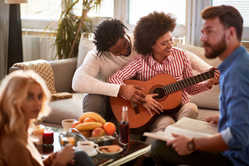 Wall Mural - Man with woman playing guitar together