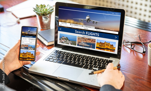 Fotografía Man working with a computer, search flights on the screen, office business background