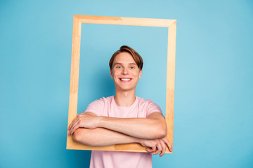 Wall Mural - Portrait of content guy hold wooden brick frame make picture of himself wear good looking outfit isolated over blue color background