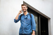 © mimagephotos - older guy walking and talking with mobile phone outside