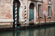 Briccole (mooring posts) on a Venetian canal, Venice, Italy